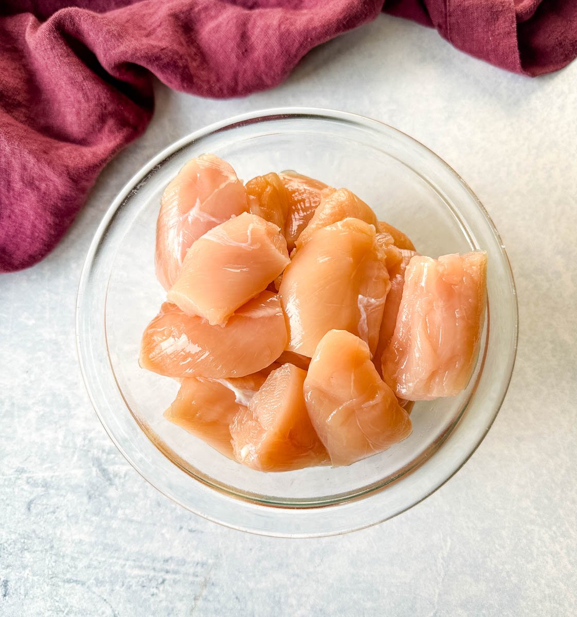 raw sliced chicken tenders in a glass bowl