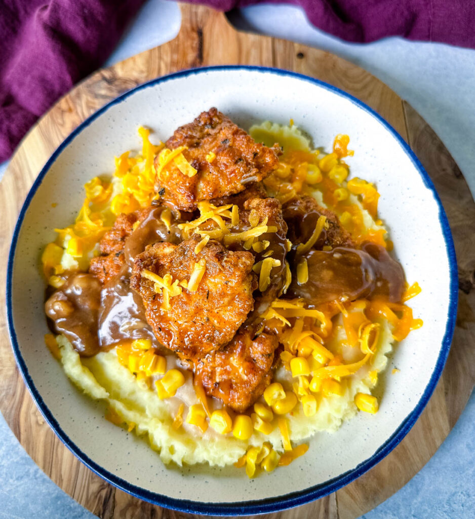 KFC famous mashed potatoes bowl with chicken, gravy, and cheese