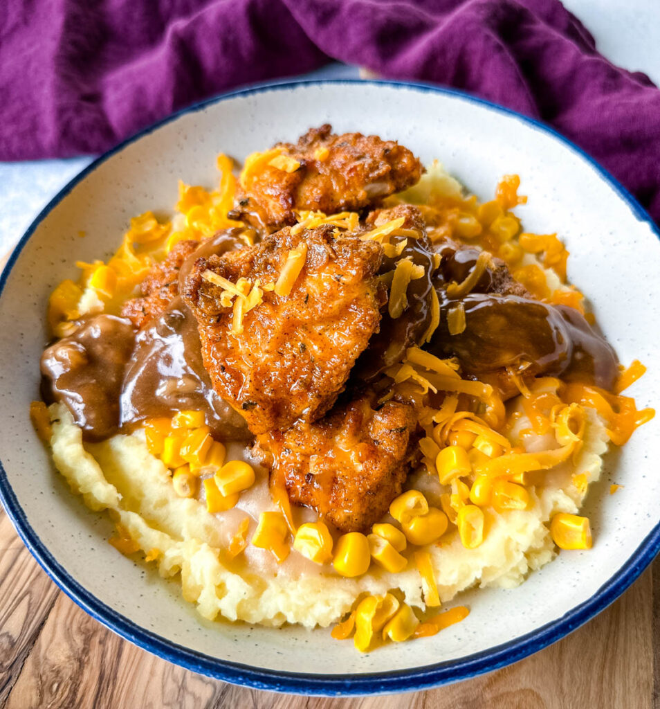 KFC famous mashed potatoes bowl with chicken, gravy, and cheese