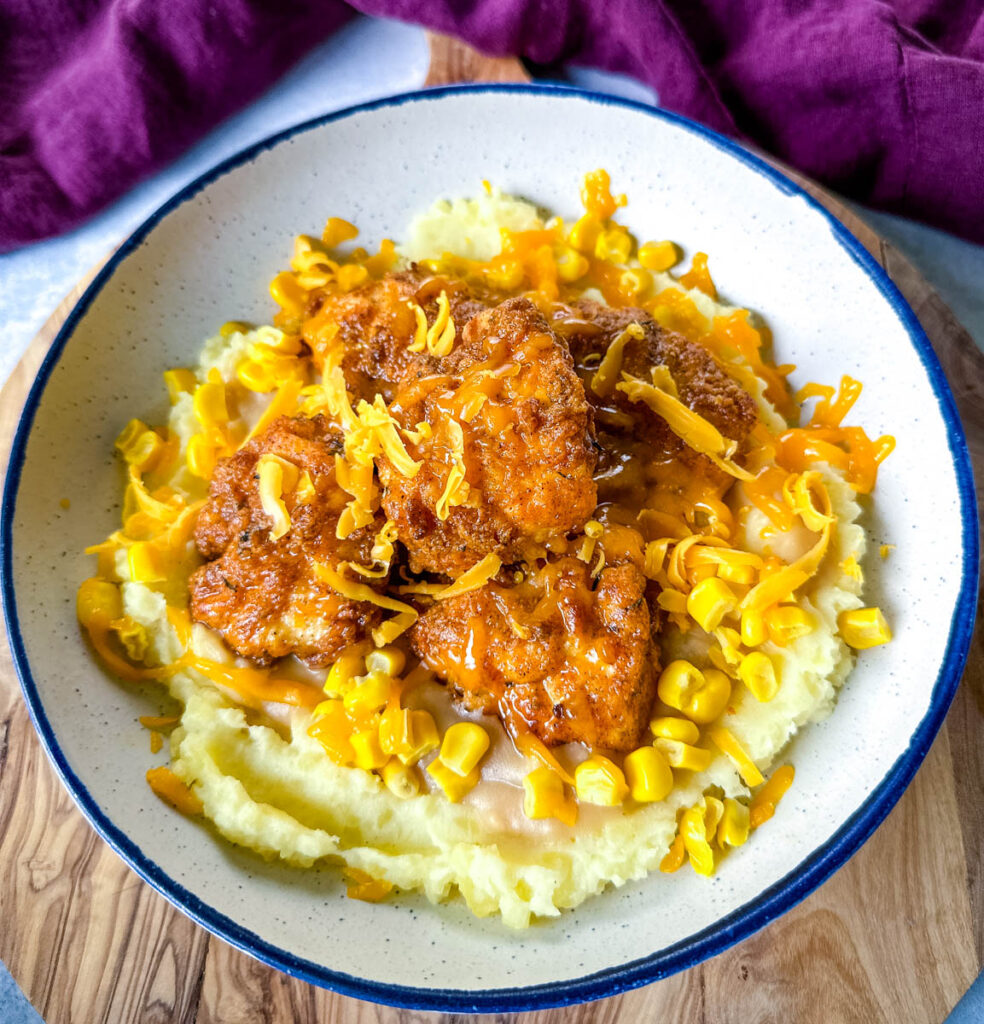 KFC famous mashed potatoes bowl with chicken, gravy, and cheese