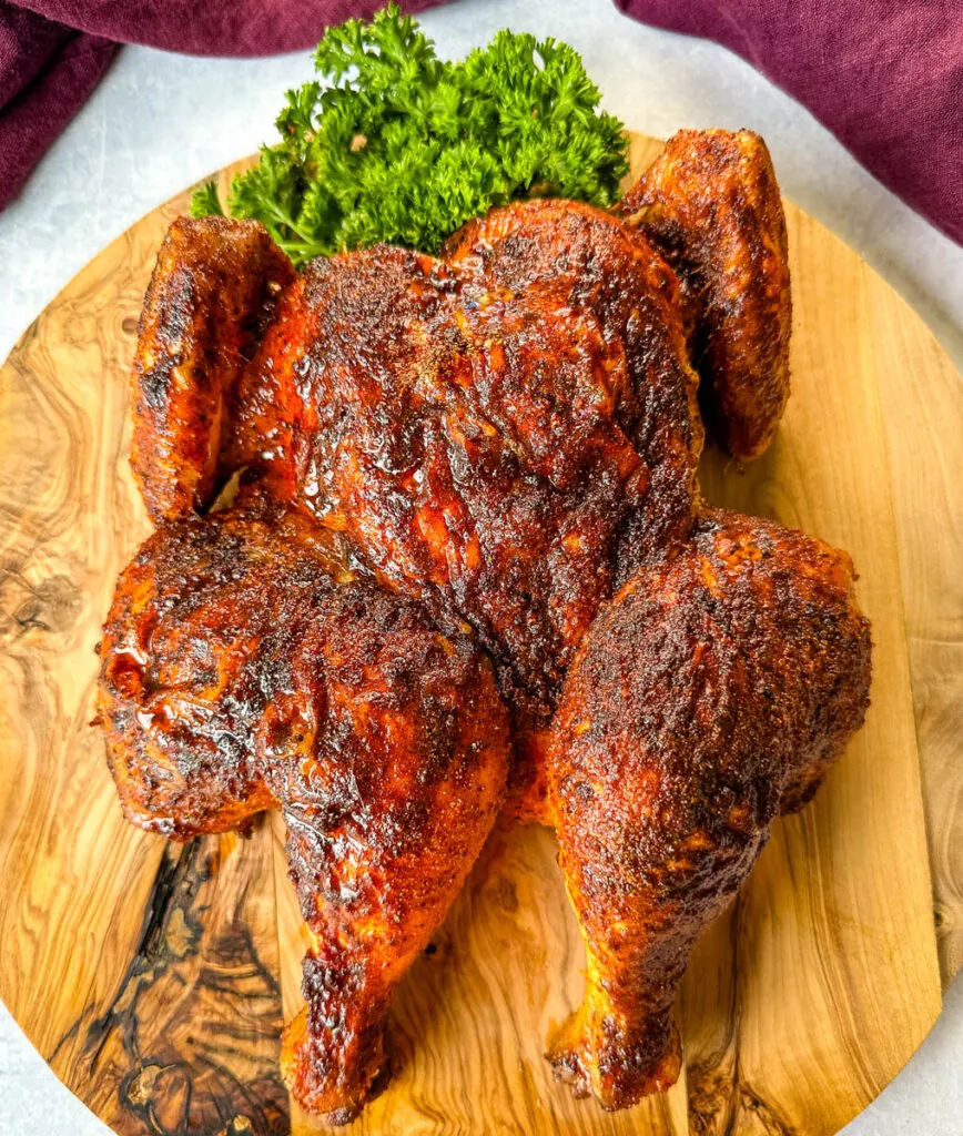baked and roasted Thanksgiving chicken on a wooden cutting board