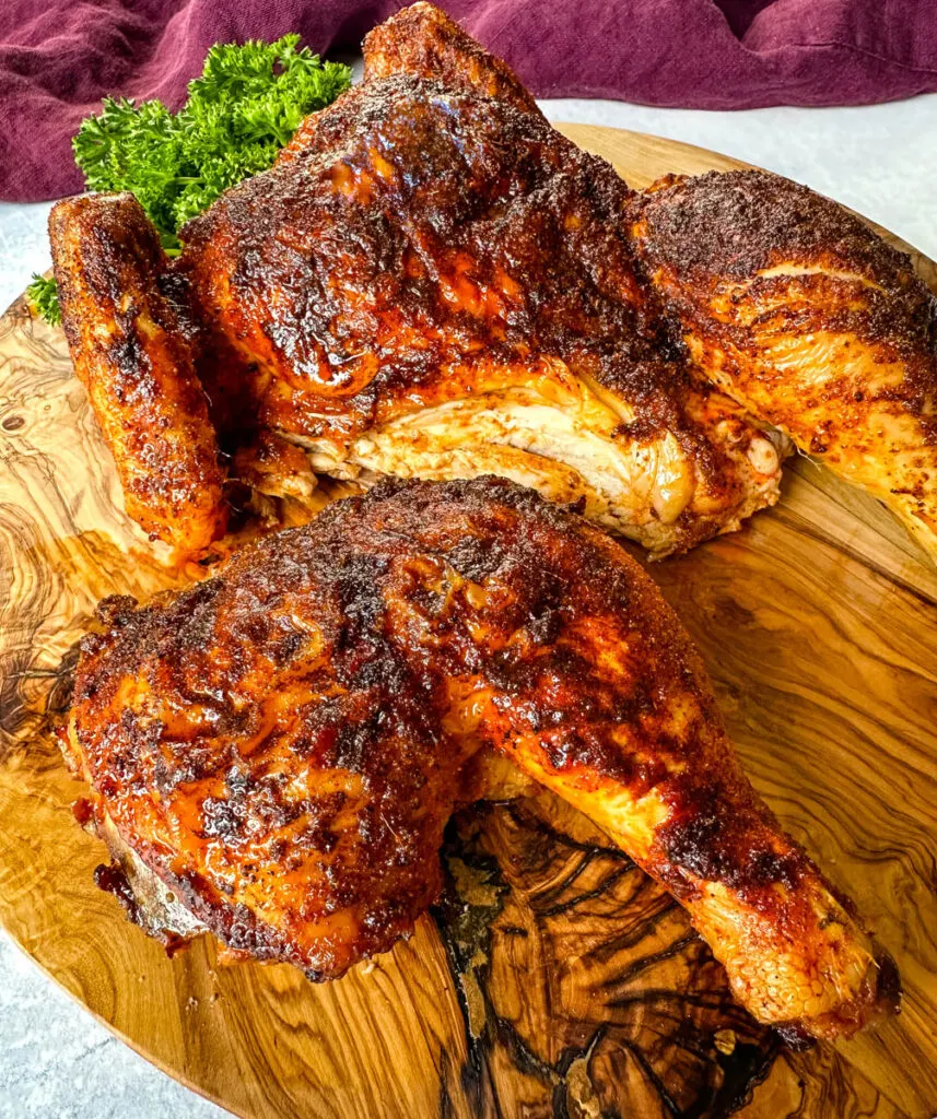 carved Thanksgiving chicken on a wooden cutting board
