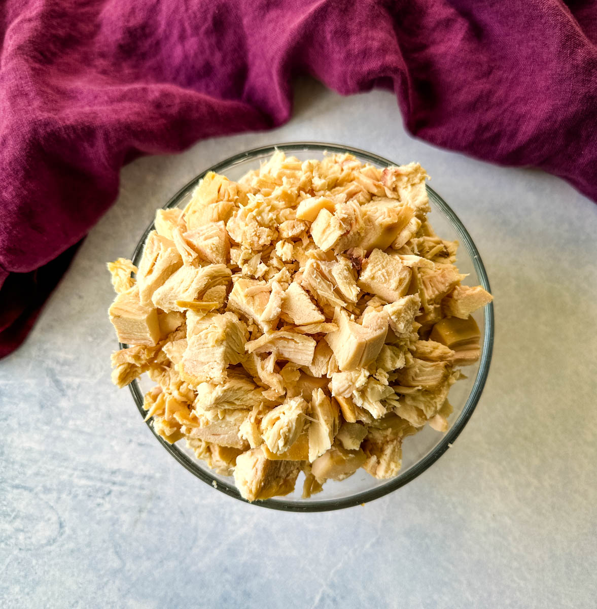 chunks of rotisserie chicken in a glass bowl