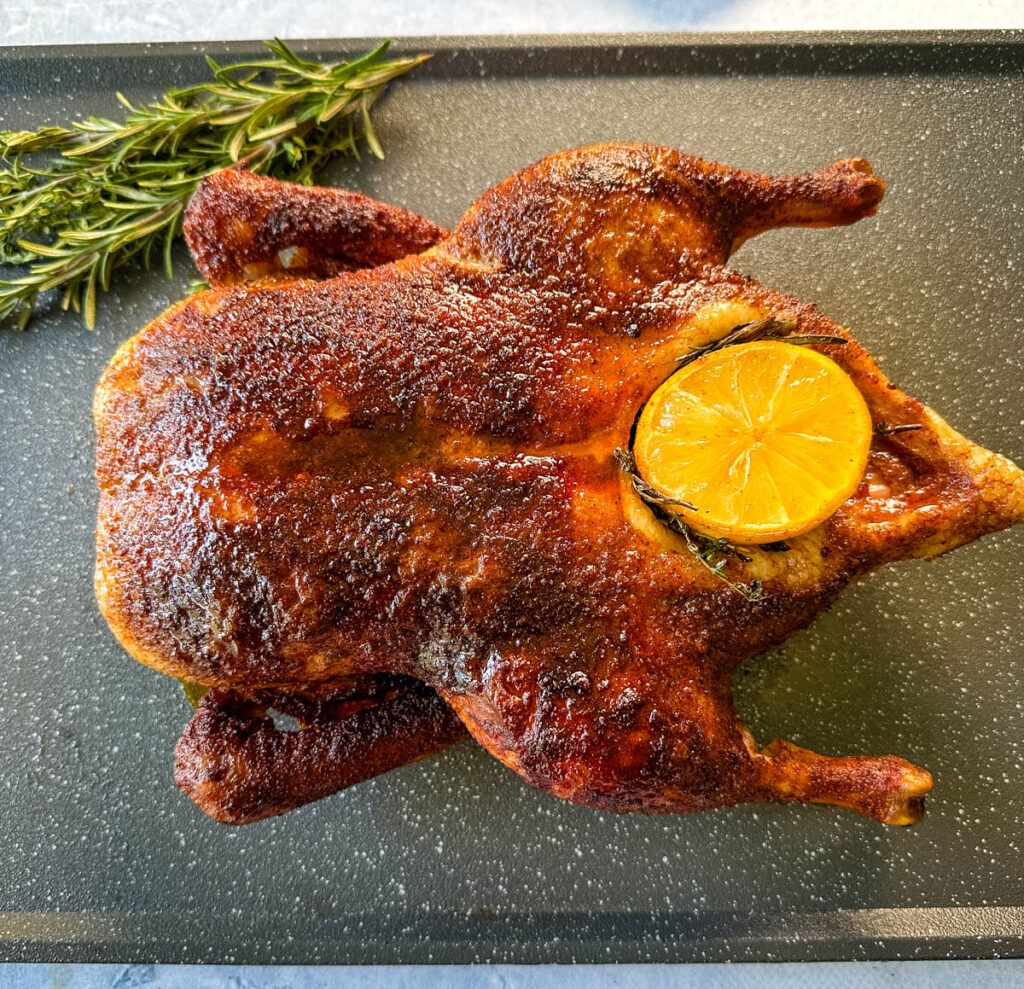 smoked duck on a sheet pan stuffed with lemon and herbs