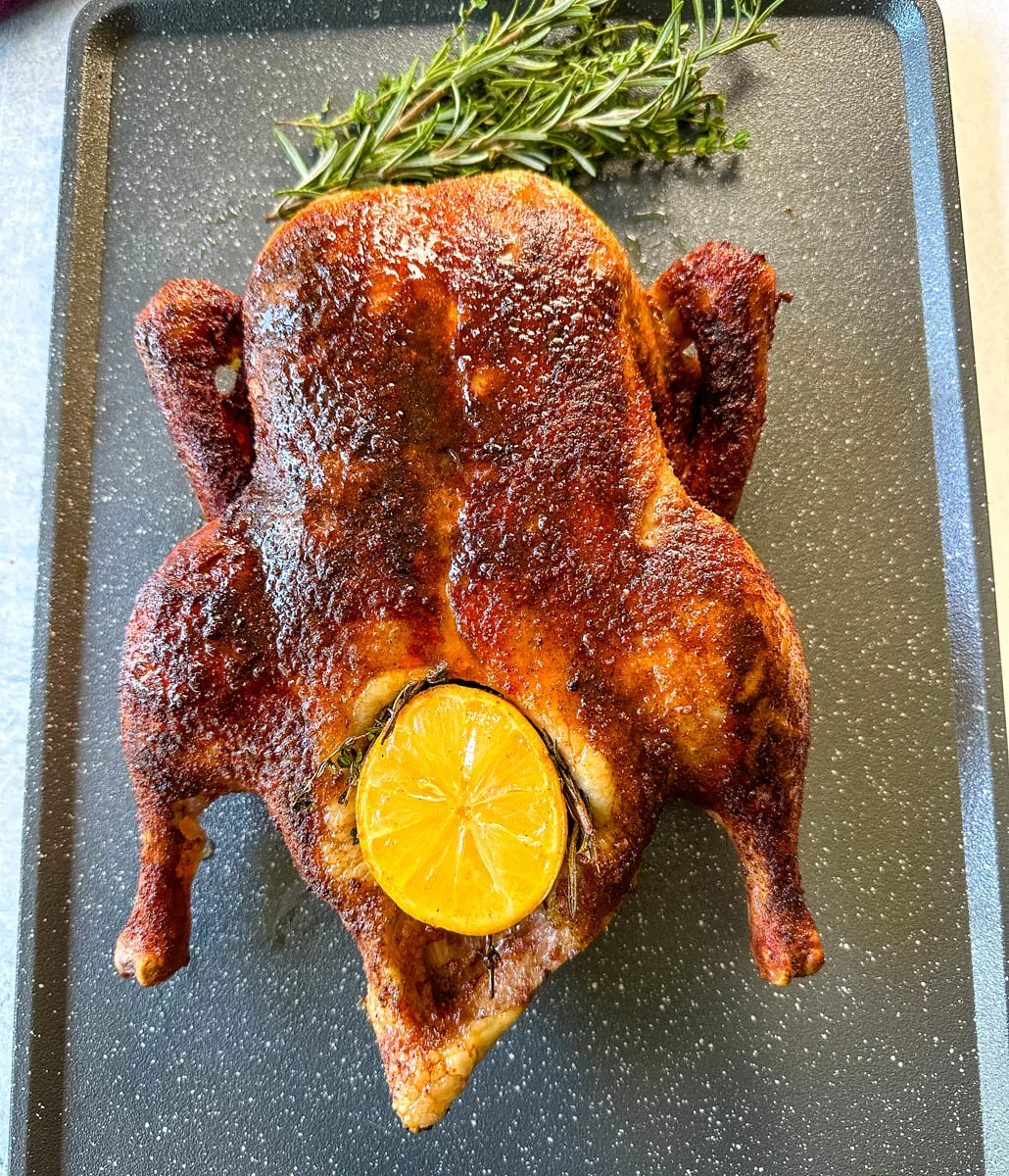 smoked duck on a sheet pan stuffed with lemon and herbs