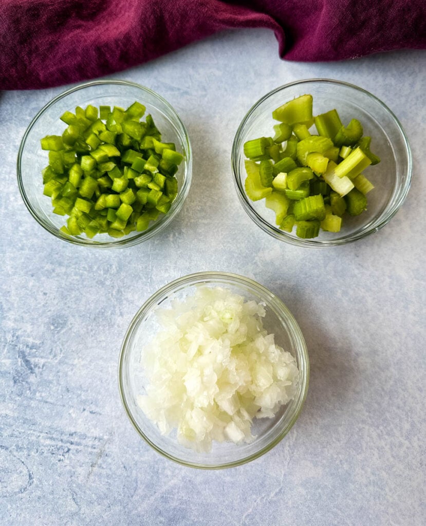diced green peppers, celery, and onions in separate glass bowls