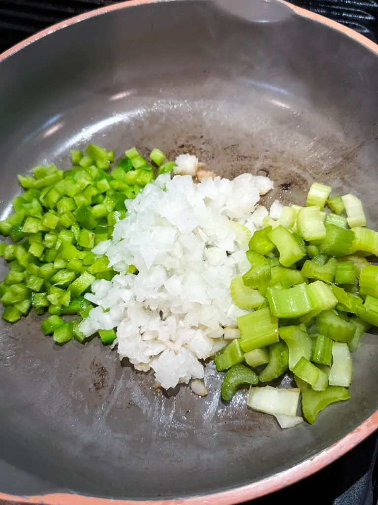 green peppers, onions, and celery in a skillet