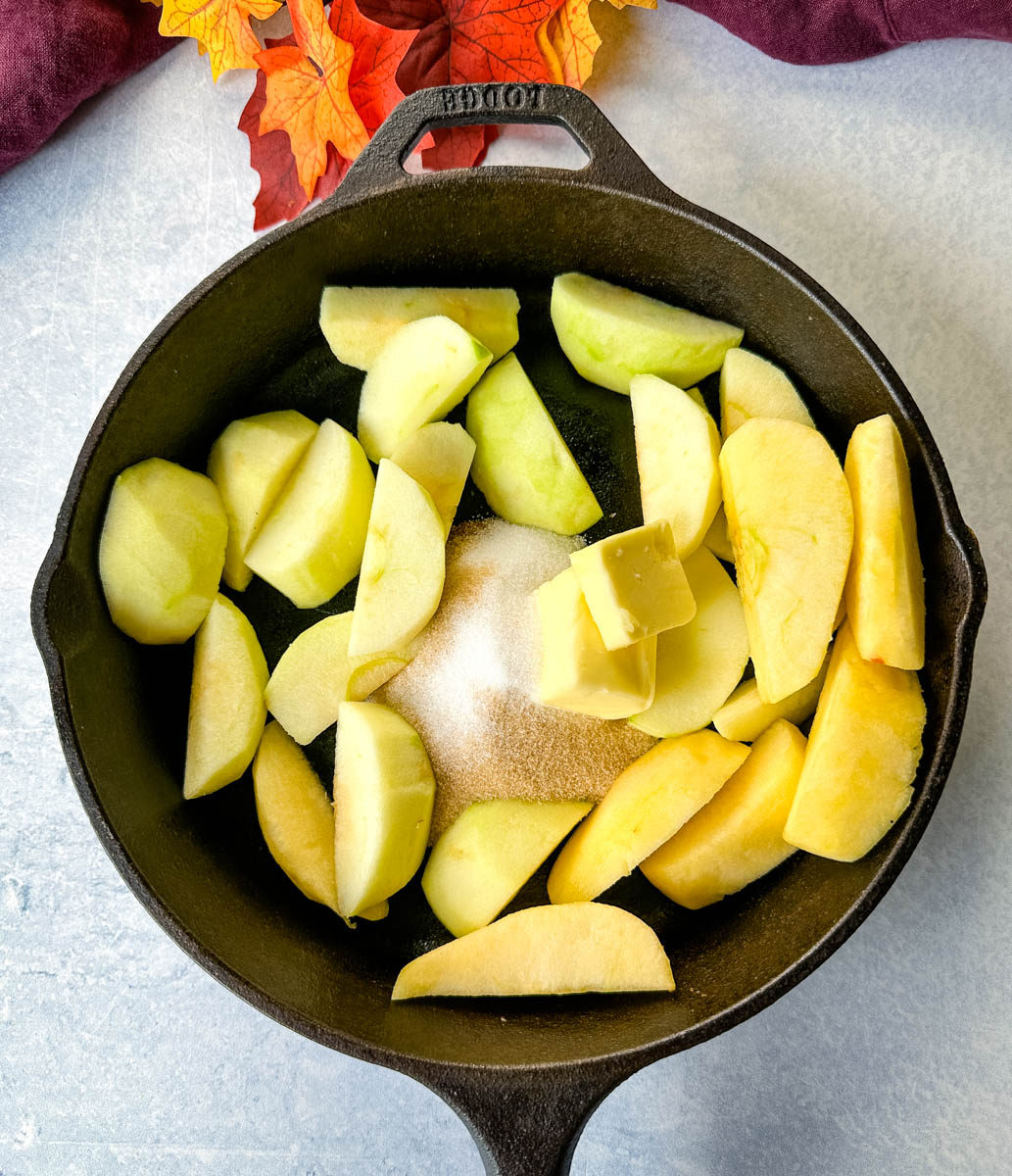 granny smith apples in a cast iron skillet with butter, cinnamon, and brown sugar