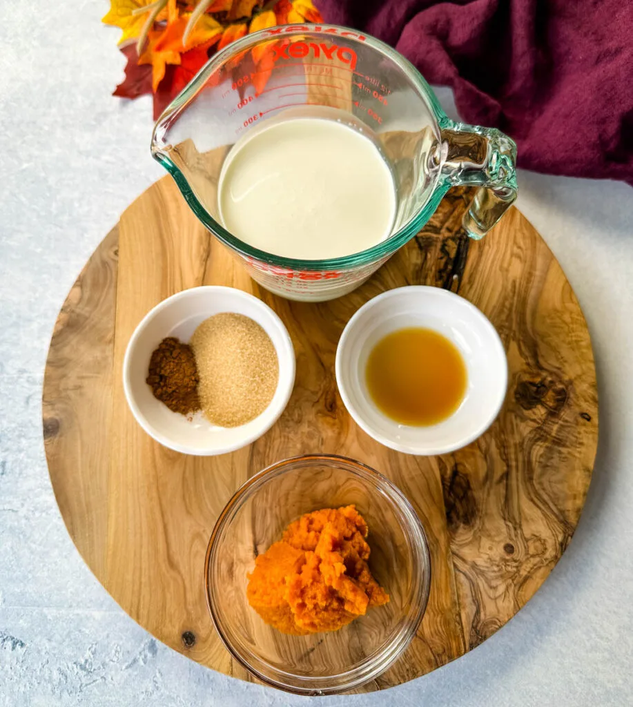 heavy cream, cinnamon, nutmeg, pure pure pumpkin, and vanilla extract in separate glass bowls