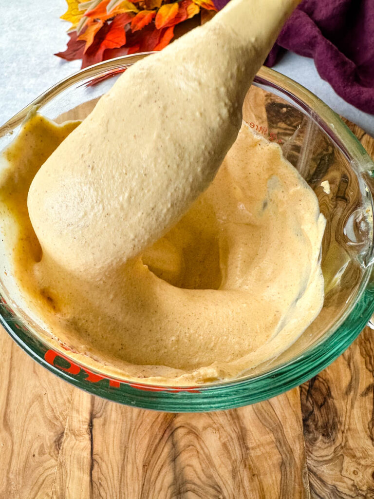 pumpkin cream in a glass bowl with a spoon