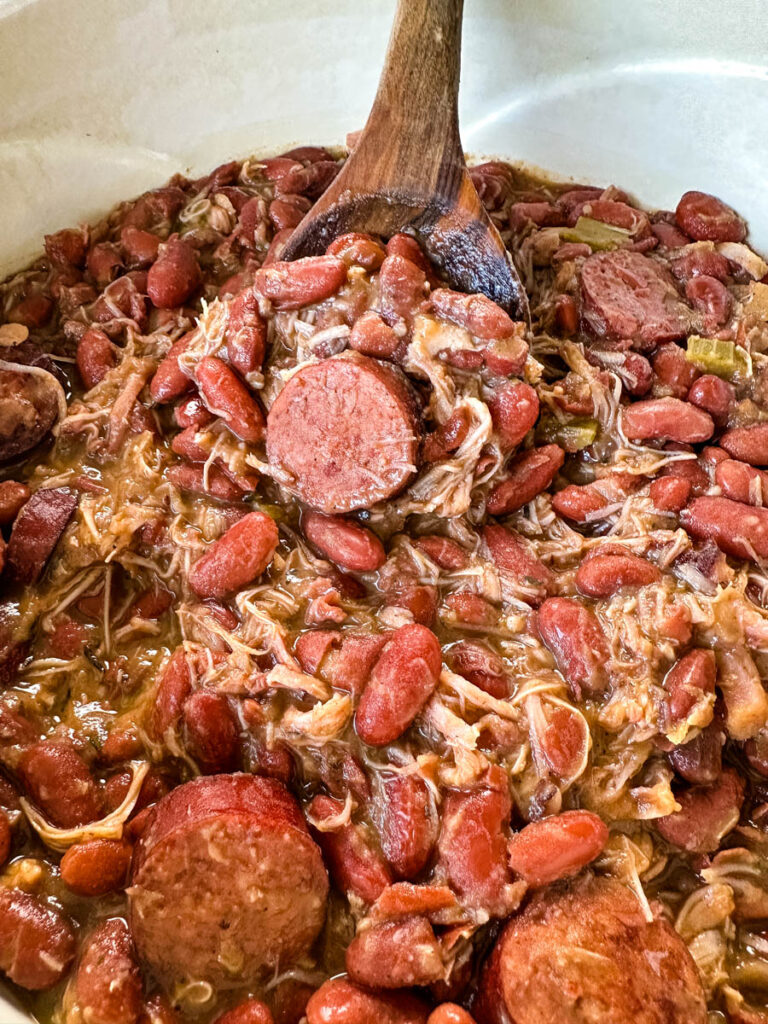 Southern Cajun red beans and rice with smoked turkey in a Dutch oven with a wooden spoon