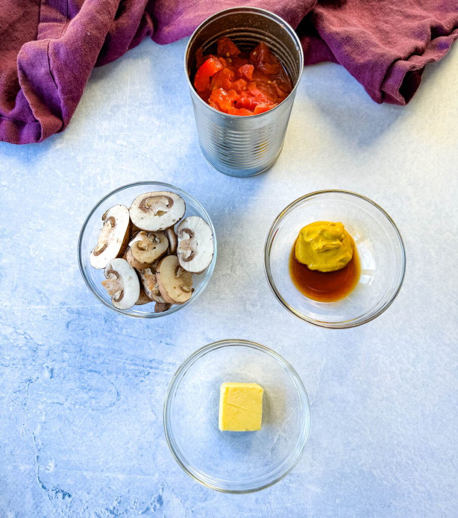 diced tomatoes in a can, fresh mushrooms, mustard, worcestershire sauce, and butter in separate glass bowls