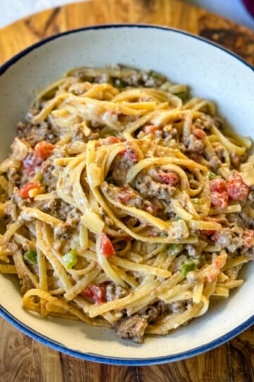 beef alfredo pasta in a white bowl