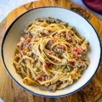 beef alfredo pasta in a white bowl