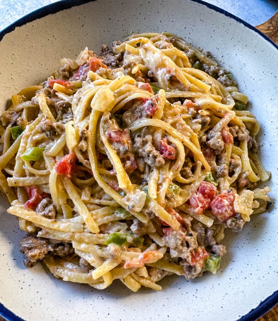 beef alfredo pasta in a white bowl