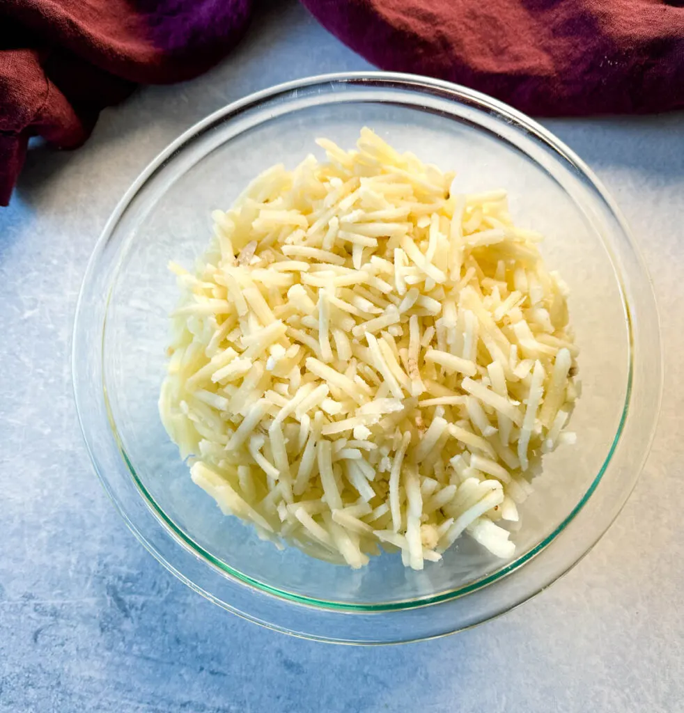 frozen shredded hash browns in a glass bowl
