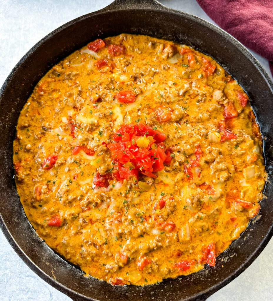 Rotel dip with ground beef in a cast iron skillet