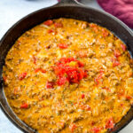 Rotel dip with ground beef in a cast iron skillet