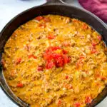 Rotel dip with ground beef in a cast iron skillet