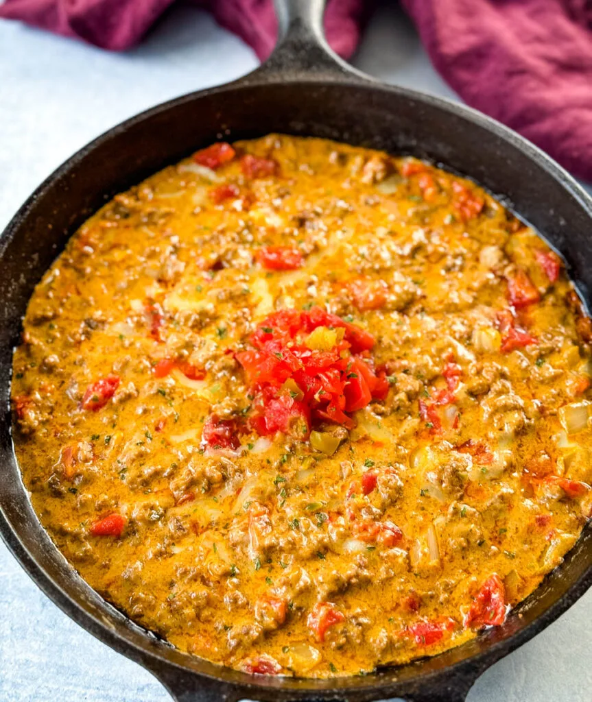 Rotel dip with ground beef in a cast iron skillet