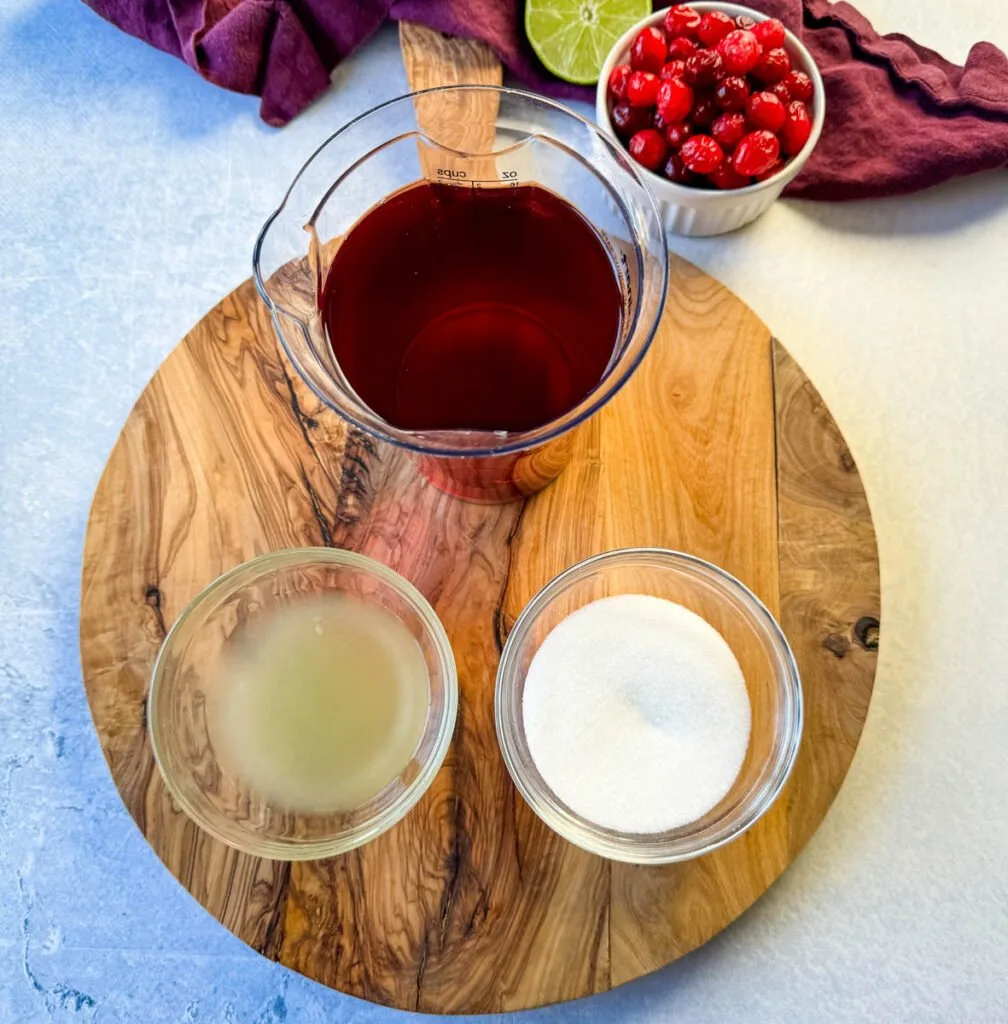 cranberry juice, lime juice, and sweetener in separate glass bowls