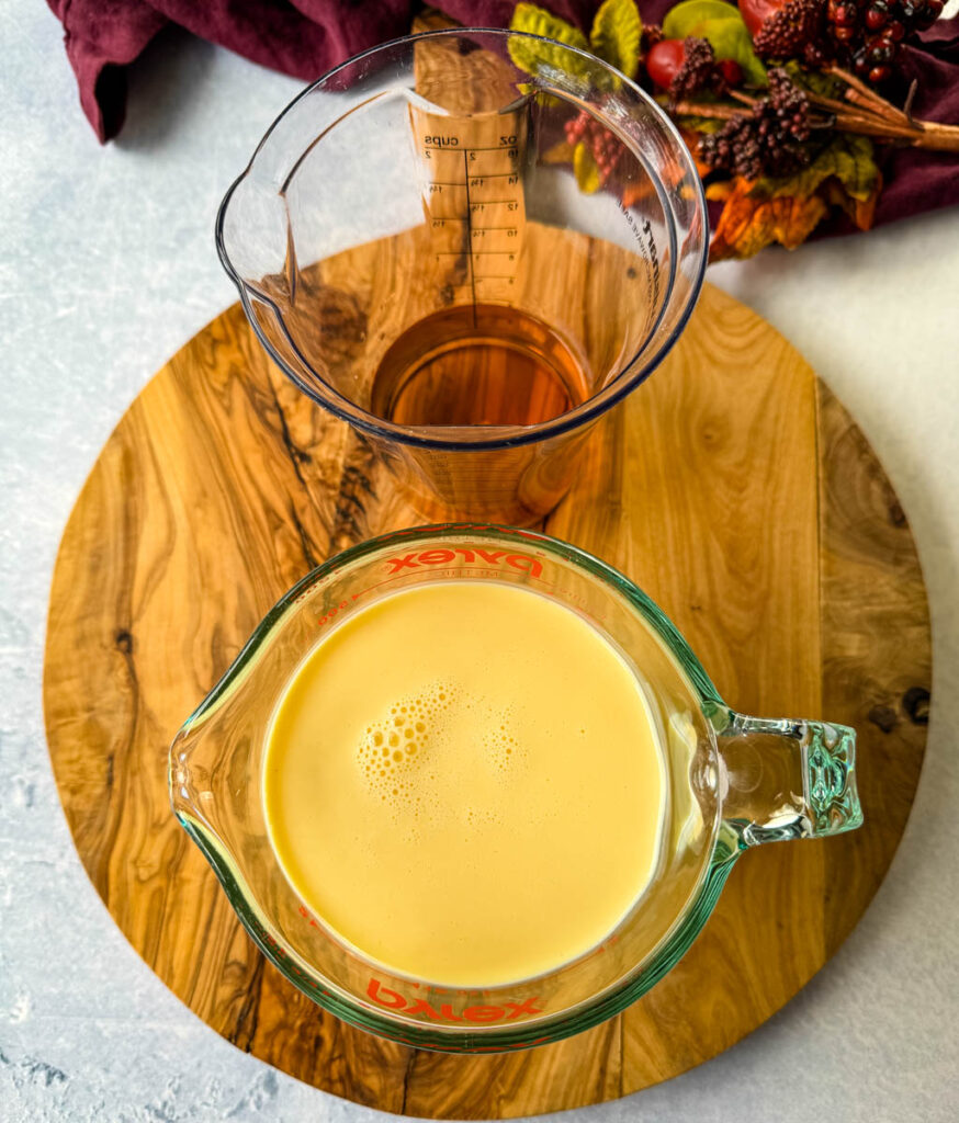 eggnog and dark liquor in separate glass cups