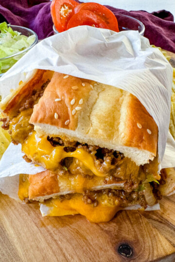 chopped cheese sandwich with lettuce and tomatoes in a wrapper