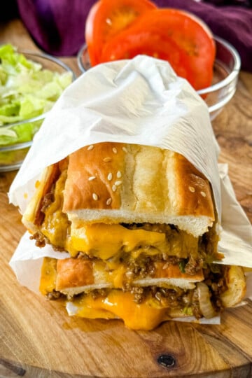 chopped cheese sandwich with lettuce and tomatoes in a wrapper