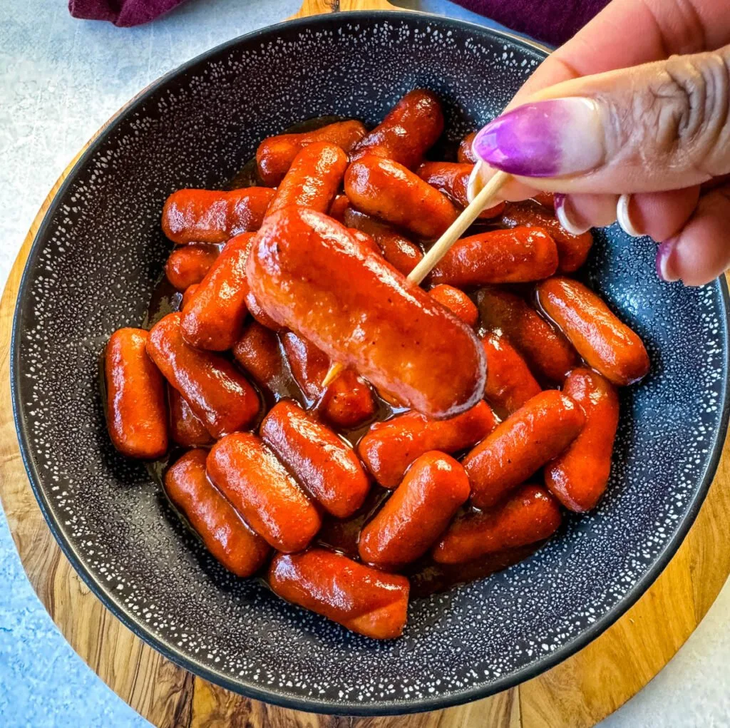 person holding Little Smokies cocktail sausage