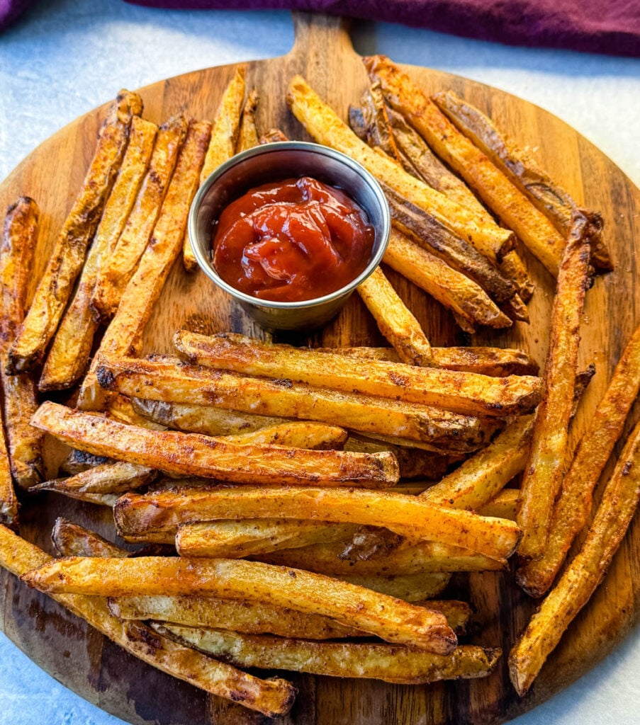 Cajun fries on a platter with ketchup