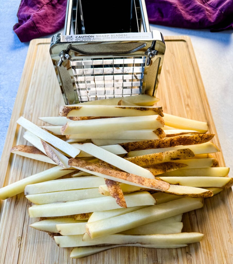 sliced russet potatoes cut into fries with a fry cutter