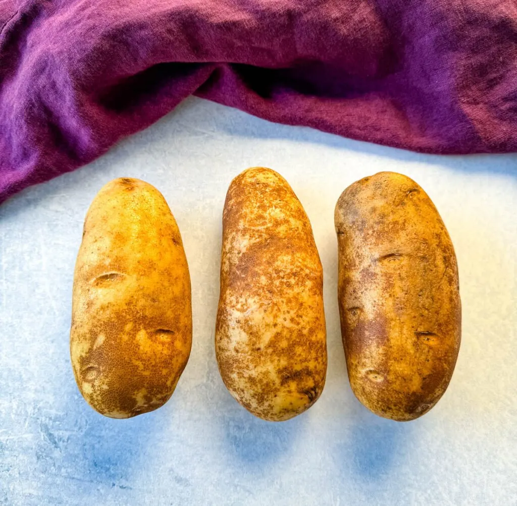 fresh russet potatoes on a flat surface