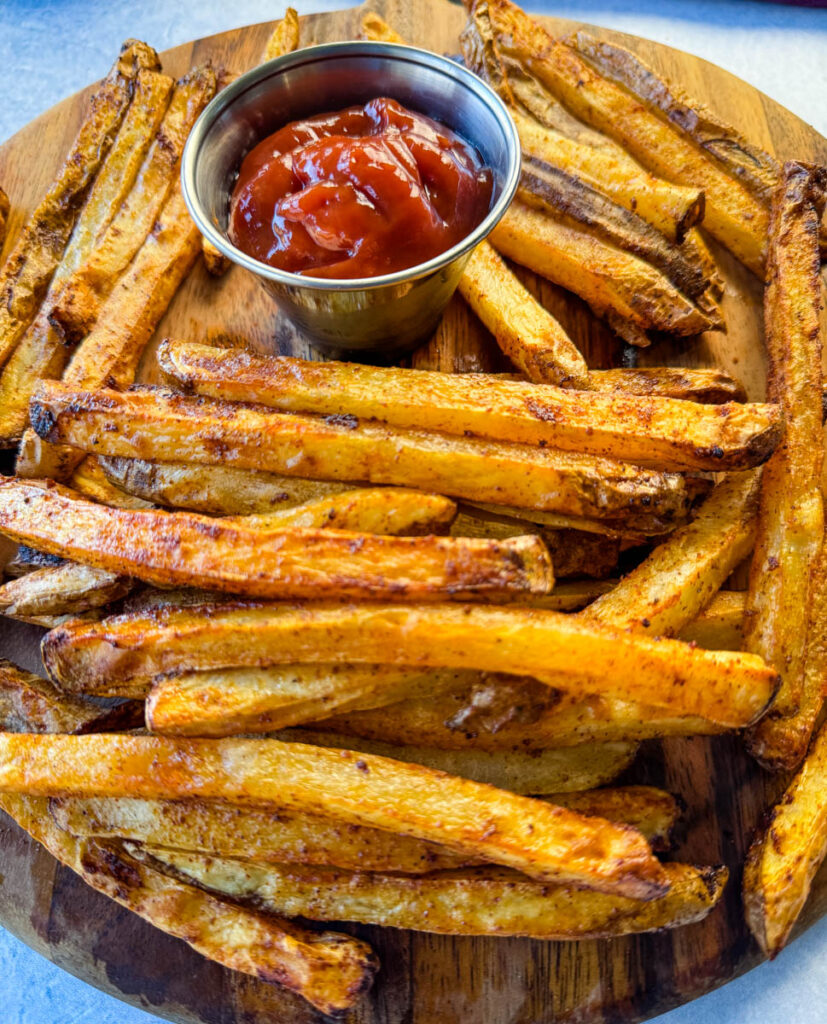 Cajun fries on a platter with ketchup