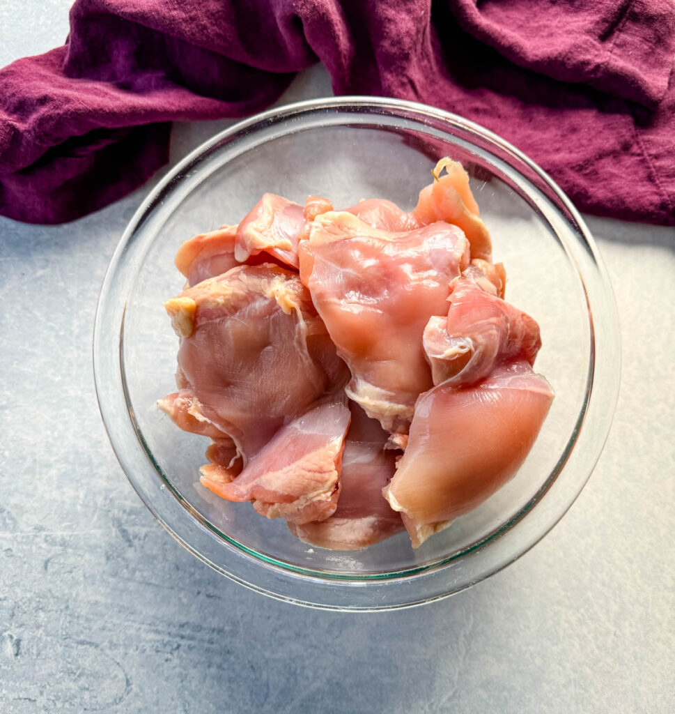 raw chicken thighs in a glass bowl