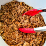 pulled chicken and BBQ sauce in a white Crockpot slow cooker