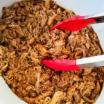 pulled chicken and BBQ sauce in a white Crockpot slow cooker