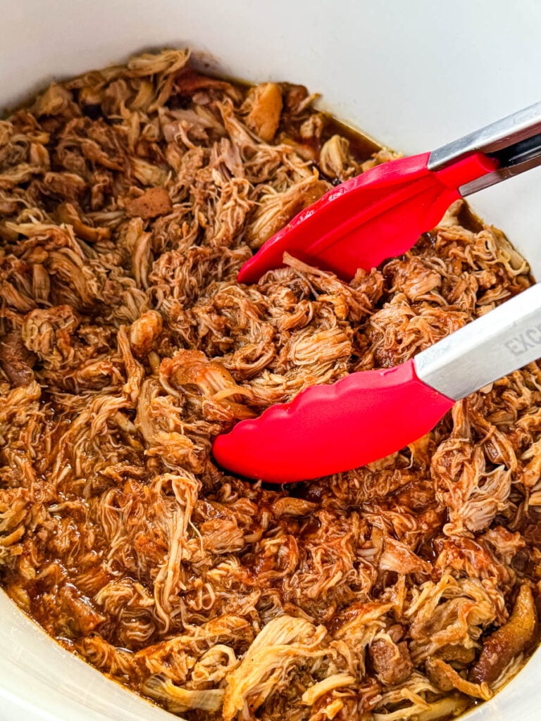 pulled chicken and BBQ sauce in a white Crockpot slow cooker