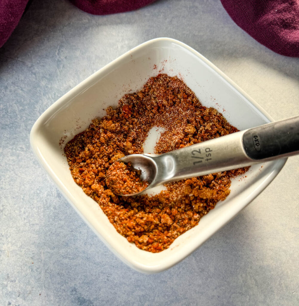 spices for rib dry rub in a white bowl with a spoon