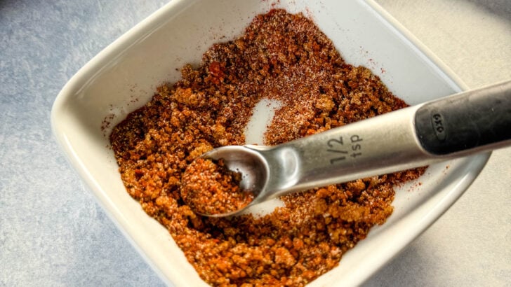 spices for rib dry rub in a white bowl with a spoon