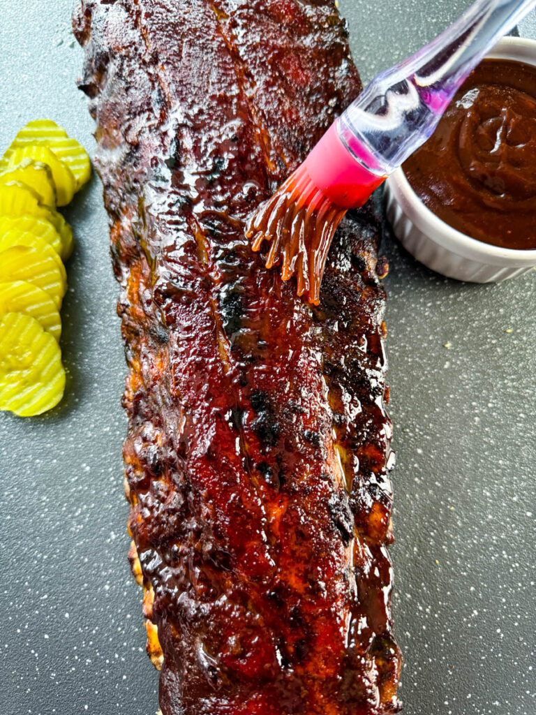 oven baked ribs brushed with BBQ sauce