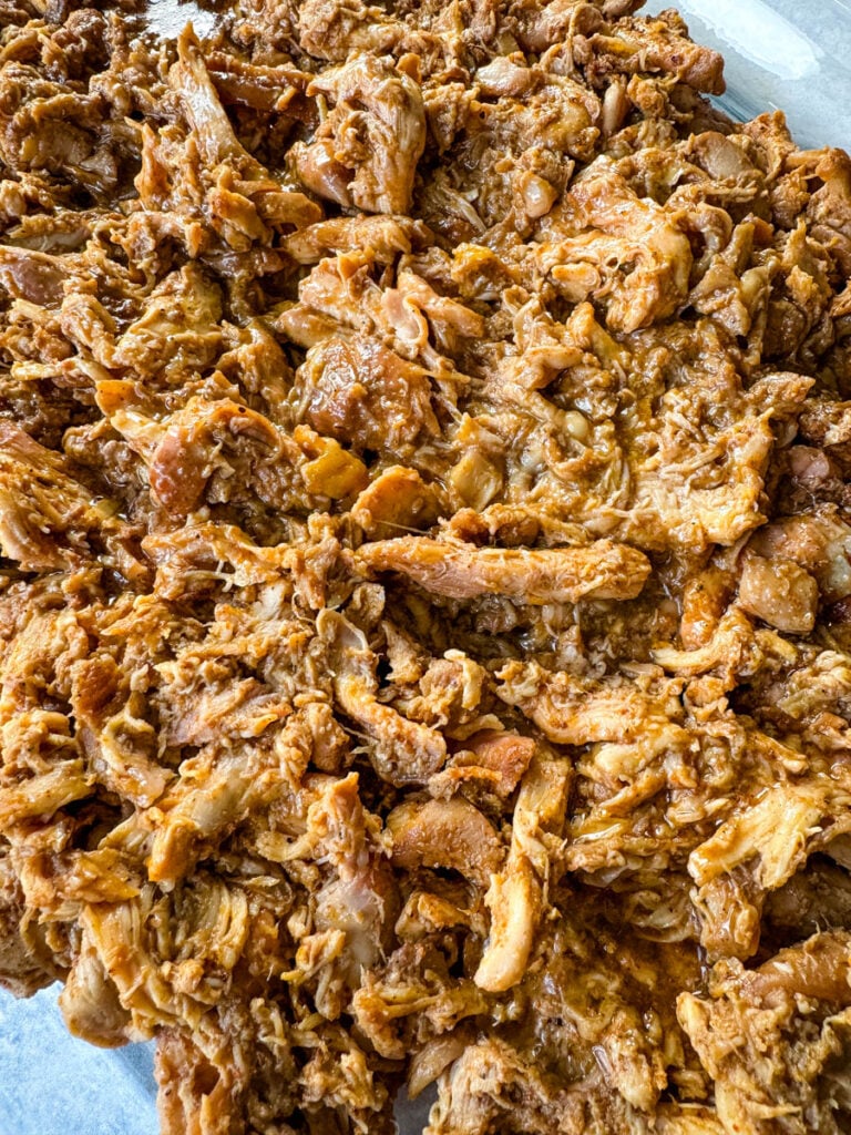 smoked pulled chicken on a clear serving tray