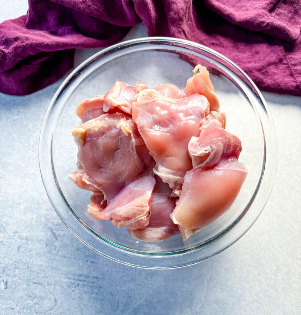 raw chicken thighs in a glass bowl