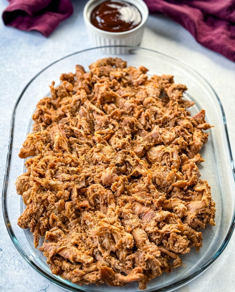 smoked pulled chicken on a clear serving tray