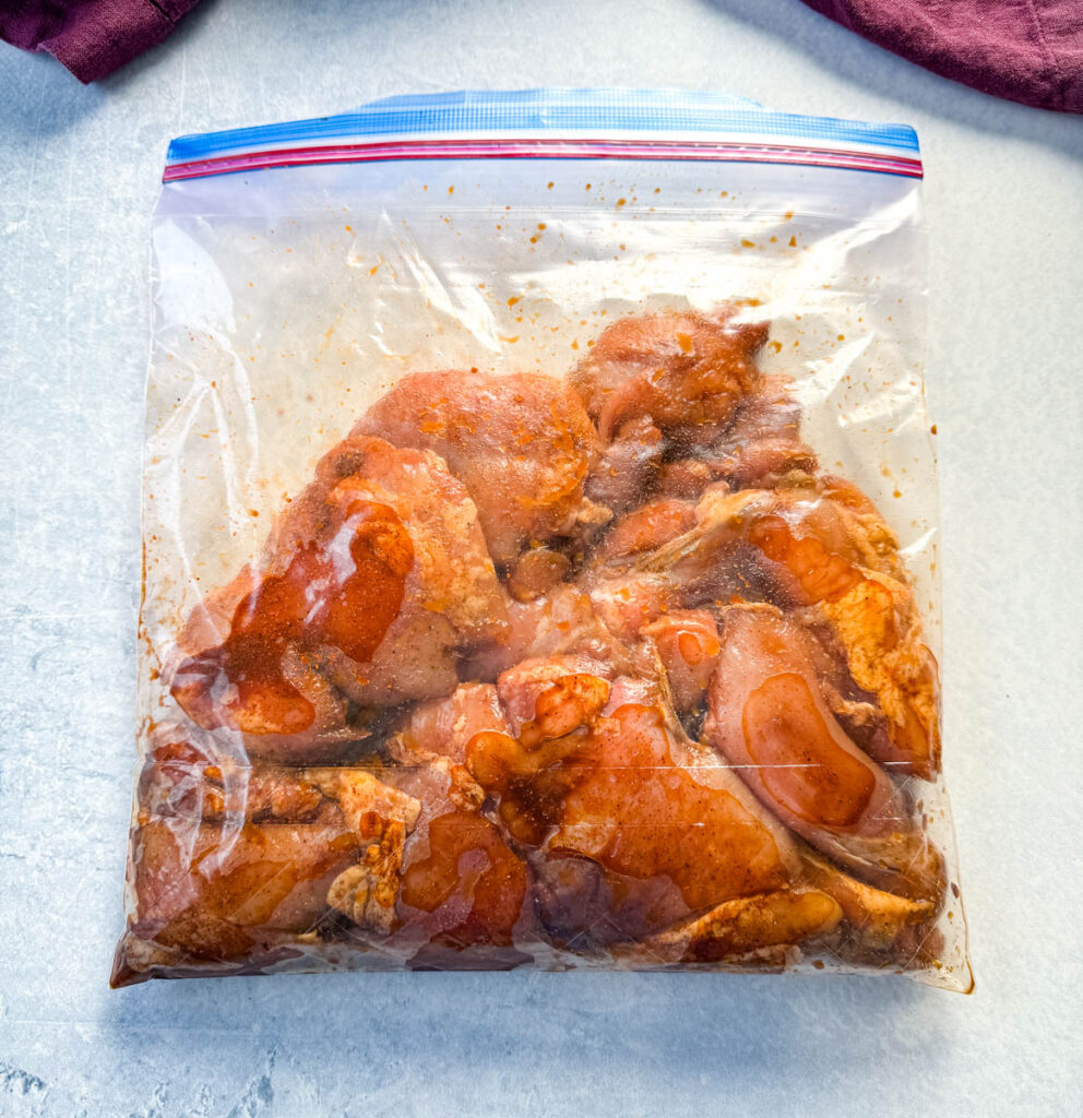 raw seasoned and marinated chicken thighs in a Ziploc bag