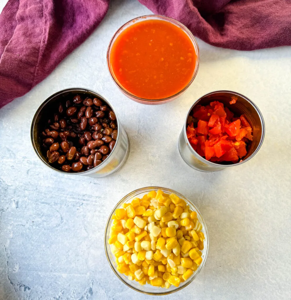 salsa, canned black beans, diced tomatoes, and kernel corn in separate cans and glass bowls
