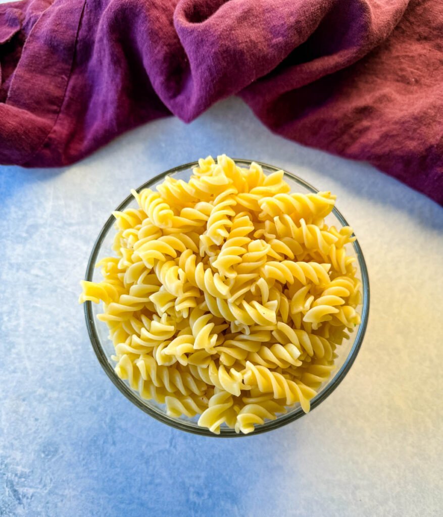 cooked rotini pasta in a glass bowl