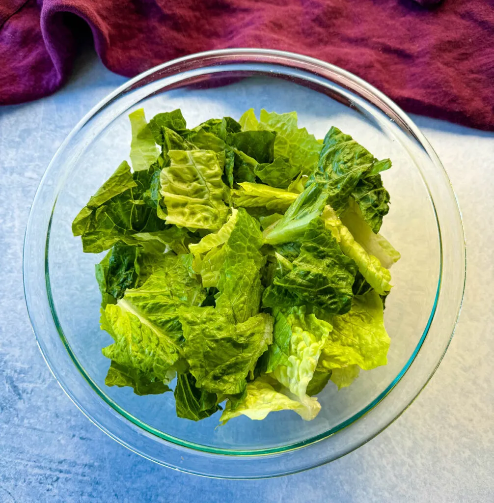 fresh romaine lettuce in a glass bowl