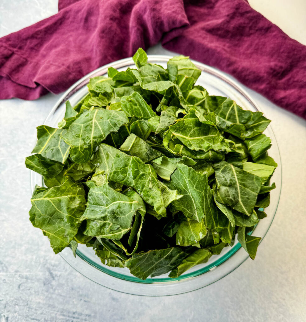 fresh collard greens in a glass bowl