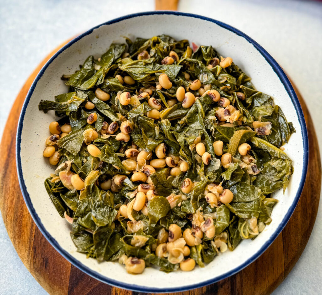 collard greens and black eyed peas in a white bowl