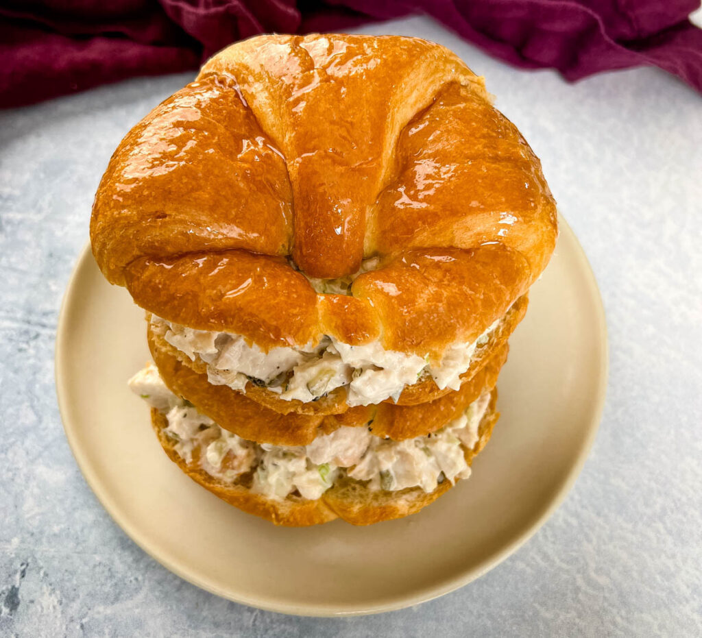 classic chicken salad on a croissant sandwich on a plate